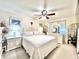 Serene main bedroom with soft lighting, a comfortable bed, and elegant white furnishings, creating a relaxing retreat at 7623 Radcliffe Cir # 211A, Port Richey, FL 34668