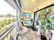 Cozy patio with woven seating and a quaint table, surrounded by plants, offering a serene outdoor space at 7623 Radcliffe Cir # 211A, Port Richey, FL 34668