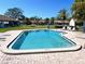 Sparkling community swimming pool with lounge chairs and clear blue water at 7623 Radcliffe Cir # 211A, Port Richey, FL 34668