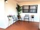 Cozy outdoor porch with seating and plants, perfect for relaxation and enjoying the view at 7623 Radcliffe Cir # 211A, Port Richey, FL 34668