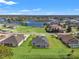 Aerial view of a house with lush green lawns and waterfront views at 8977 Players Dr, Brooksville, FL 34613