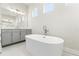 Bright bathroom featuring a modern soaking tub and double sink vanity at 8977 Players Dr, Brooksville, FL 34613