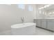 Bright bathroom featuring a modern soaking tub and double sink vanity at 8977 Players Dr, Brooksville, FL 34613