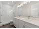 Bathroom featuring double sinks, white cabinets, and a glass enclosed shower at 8977 Players Dr, Brooksville, FL 34613