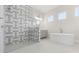 Bright bathroom with glass enclosed shower and modern soaking tub at 8977 Players Dr, Brooksville, FL 34613