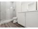 Bathroom featuring a glass enclosed shower, white tiling, and a sleek white vanity at 8977 Players Dr, Brooksville, FL 34613