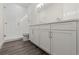 Bathroom with white cabinets, double sinks, quartz countertops and glass shower at 8977 Players Dr, Brooksville, FL 34613