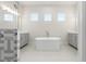Bright bathroom featuring a large soaking tub and double sink vanity at 8977 Players Dr, Brooksville, FL 34613