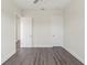 Bedroom featuring laminate flooring, neutral paint, and a hallway leading to other rooms at 8977 Players Dr, Brooksville, FL 34613