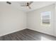 Bedroom featuring a modern ceiling fan and a window offering ample natural light at 8977 Players Dr, Brooksville, FL 34613