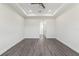 Spacious bedroom features tray ceiling, fan, and modern gray flooring at 8977 Players Dr, Brooksville, FL 34613