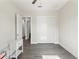 Bedroom with a ceiling fan, closet, and gray wood floors at 8977 Players Dr, Brooksville, FL 34613