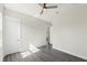 Bedroom featuring laminate flooring, neutral paint, and a hallway leading to other rooms at 8977 Players Dr, Brooksville, FL 34613