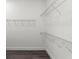 Walk-in closet features white wire shelving and laminate flooring at 8977 Players Dr, Brooksville, FL 34613