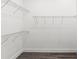 Walk-in closet with wire shelving and gray laminate flooring at 8977 Players Dr, Brooksville, FL 34613