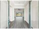The open entryway has a direct view to the sliding glass doors to the outside at 8977 Players Dr, Brooksville, FL 34613