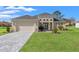 Inviting single-story home with manicured lawn, paved driveway, and attached two-car garage at 8977 Players Dr, Brooksville, FL 34613
