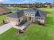 Beautiful single-Gathering home with lush landscaping and a two-car garage, set against a golf course at 8977 Players Dr, Brooksville, FL 34613