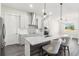 Modern kitchen with island, pendant lights, and stainless steel appliances at 8977 Players Dr, Brooksville, FL 34613