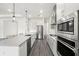 Modern kitchen with stainless steel appliances, hardwood floors, and sleek countertops at 8977 Players Dr, Brooksville, FL 34613