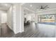 Open concept living space with hardwood floors, modern lighting, and kitchen access at 8977 Players Dr, Brooksville, FL 34613