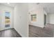 Bright living room with gray wood floors and a view to the outside at 8977 Players Dr, Brooksville, FL 34613