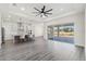 Open concept living room with a large sliding glass door leading to a patio and a kitchen with bar seating at 8977 Players Dr, Brooksville, FL 34613