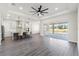 Open-concept area with a fan, leading to a modern kitchen and outdoor patio at 8977 Players Dr, Brooksville, FL 34613
