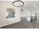Open-concept living room with a large window view, dark floors, and access to the kitchen and dining areas at 8977 Players Dr, Brooksville, FL 34613