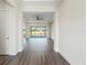 Bright living room with hardwood floors leading to sliding doors and outdoor view at 8977 Players Dr, Brooksville, FL 34613