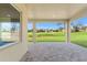 Covered patio with brick pavers offers serene views of the golf course and surrounding greenery at 8977 Players Dr, Brooksville, FL 34613