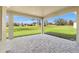 Covered patio with brick pavers overlooks lush greenery and a picturesque golf course at 8977 Players Dr, Brooksville, FL 34613