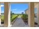 Scenic view from the walkway leading to the house, surrounded by lush greenery and landscaping at 8977 Players Dr, Brooksville, FL 34613