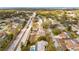 Neighborhood view showcasing the home's proximity to the roadway, mature trees, and community features at 1240 Ridgegrove S Dr, Palm Harbor, FL 34683