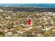 Aerial view of neighborhood featuring mature trees, a beautiful skyline in the distance, and a lovely home at 1240 Ridgegrove S Dr, Palm Harbor, FL 34683