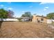 Spacious backyard featuring a pool, screen enclosure, white fence, and mature trees at 1240 Ridgegrove S Dr, Palm Harbor, FL 34683