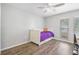Comfortable bedroom with a day bed, wood-look floors and a view of the neighborhood at 1240 Ridgegrove S Dr, Palm Harbor, FL 34683