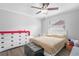 Light filled bedroom featuring wood look floors, ceiling fan, and a dresser at 1240 Ridgegrove S Dr, Palm Harbor, FL 34683