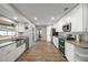 Modern kitchen with stainless steel appliances, granite countertops, white cabinets, and durable wood-look flooring at 1240 Ridgegrove S Dr, Palm Harbor, FL 34683