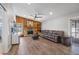 Spacious living room with a stone fireplace, modern flooring, comfortable seating, and lots of natural light at 1240 Ridgegrove S Dr, Palm Harbor, FL 34683