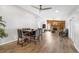 Bright and airy living room featuring wood-look floors, a fireplace, and an open floor plan at 1240 Ridgegrove S Dr, Palm Harbor, FL 34683