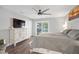 Spacious main bedroom with a view of the pool, ceiling fan, and wood-look floors at 1240 Ridgegrove S Dr, Palm Harbor, FL 34683