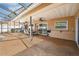 Outdoor living area features a covered patio with a dining set, outdoor seating, and a fan at 1240 Ridgegrove S Dr, Palm Harbor, FL 34683