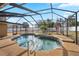 Inviting screened-in pool and spa area featuring ample deck space and meticulous tiling work at 1240 Ridgegrove S Dr, Palm Harbor, FL 34683