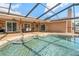 Screened-in pool with easy access to the covered patio and outdoor dining area at 1240 Ridgegrove S Dr, Palm Harbor, FL 34683