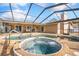 Relaxing screened-in pool and spa featuring patio area ideal for outdoor dining and entertaining at 1240 Ridgegrove S Dr, Palm Harbor, FL 34683