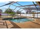 Inviting screened-in pool area with spa, landscaping, and ample space for relaxation and enjoyment at 1240 Ridgegrove S Dr, Palm Harbor, FL 34683