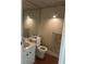 Bathroom featuring a mirror and light fixtures above the toilet and vanity sink at 1811 Bedford Ln # 162, Sun City Center, FL 33573