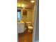 Bathroom featuring a toilet, a vanity, and a mirror at 1811 Bedford Ln # 162, Sun City Center, FL 33573