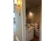Bathroom with decorative light fixture, mirror, and vanity sink and toilet at 1811 Bedford Ln # 162, Sun City Center, FL 33573